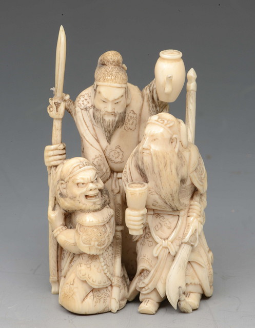 Appraisal: AN IVORY OKIMONO of three warriors known as the Three