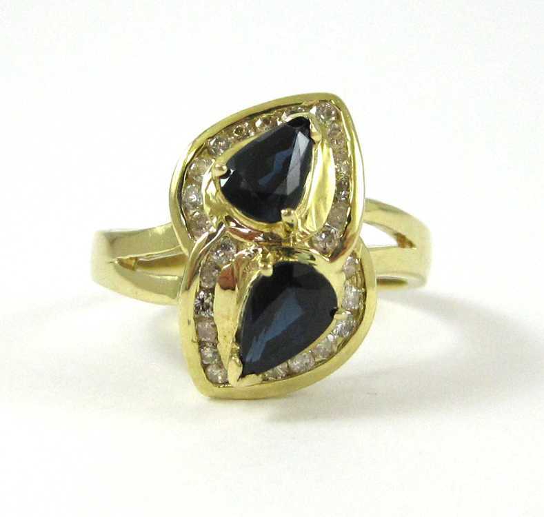 Appraisal: DIAMOND BLUE SAPPHIRE AND FOURTEEN KARAT GOLD RING featuring a