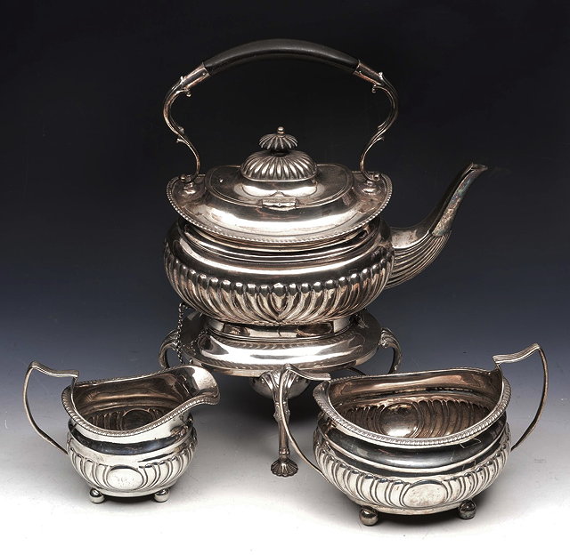 Appraisal: AN EDWARDIAN SILVER TEA KETTLE ON STAND of half lobed