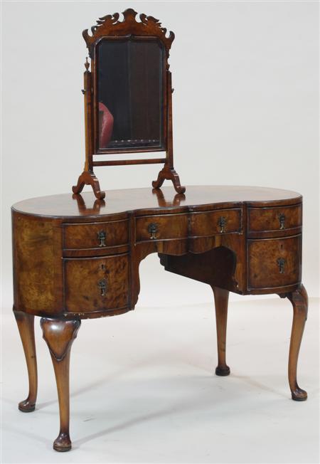 Appraisal: A Queen Anne style walnut kidney dressing table the moulded