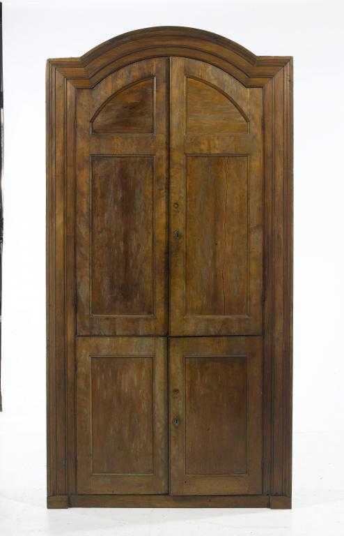 Appraisal: A GEORGE III FRUITWOOD BREAKARCHED CORNER CUPBOARD with architectural moulded