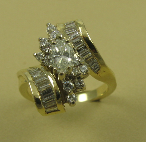 Appraisal: DIAMOND AND FOURTEEN KARAT GOLD RING centering a marquise-cut diamond