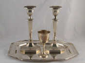 Appraisal: A pair of silver candlesticks the tapering hexagonal columns with