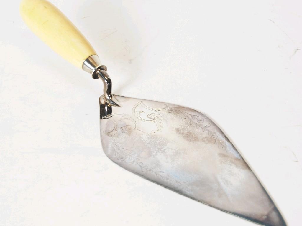 Appraisal: SILVER CEREMONIAL TROWEL WITH floral and rococo scroll engraved top