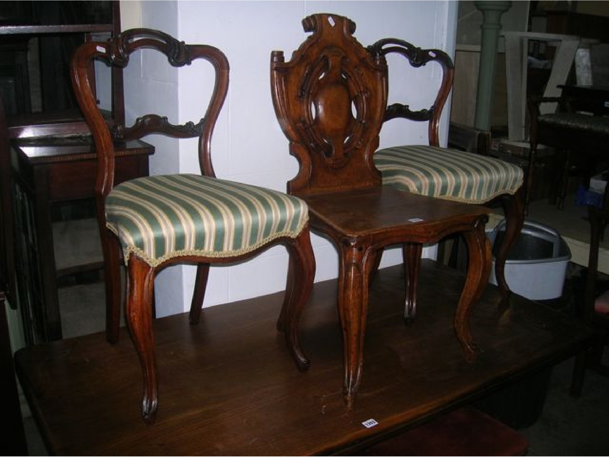 Appraisal: A Victorian oak hall chair the shield shaped panelled back