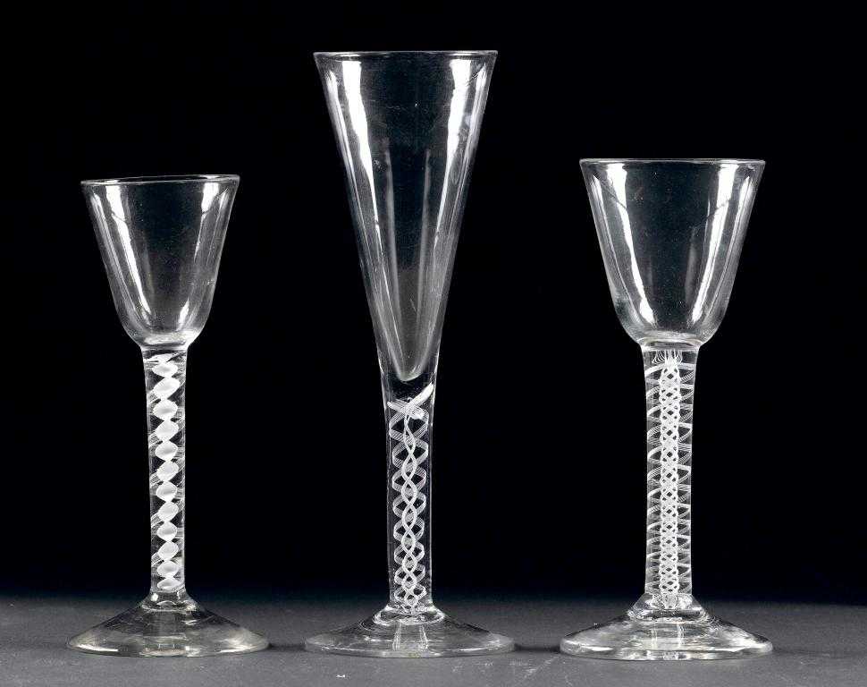 Appraisal: THREE ENGLISH WINE GLASSES the rounded funnel or drawn trumpet