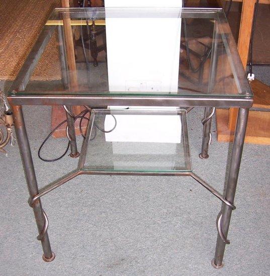 Appraisal: A square glass top table with platform under conjoined by