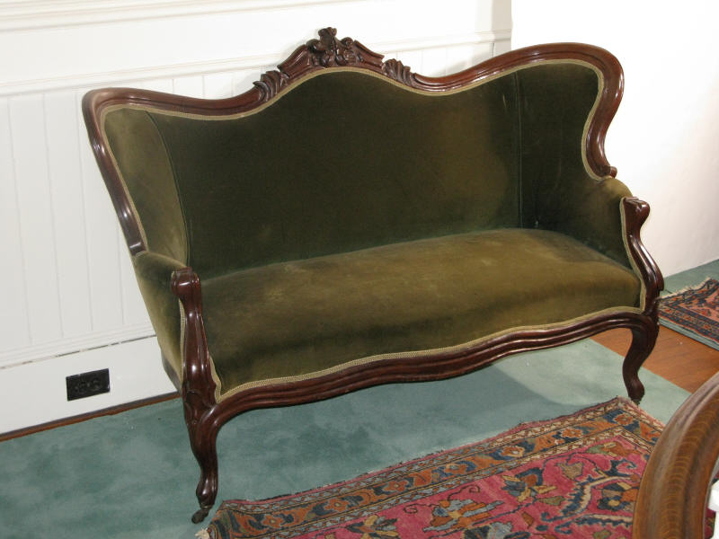 Appraisal: Victorian Settee mahogany frame with shaped back central foliate carved