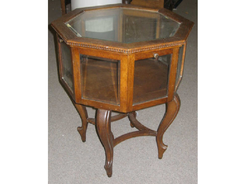 Appraisal: CONTINENTAL OAK OCTAGONAL VITRINE TABLE Top inset with beveled glass