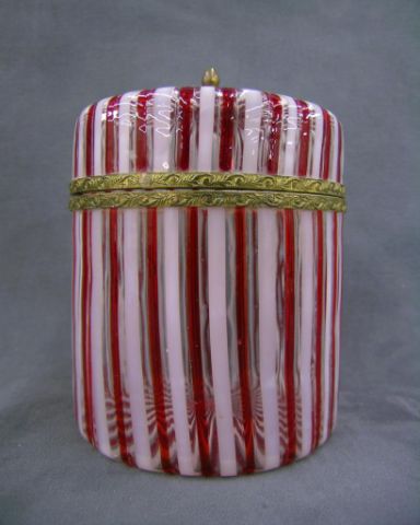 Appraisal: Victorian red and white ribbon glass hinged round dresser box