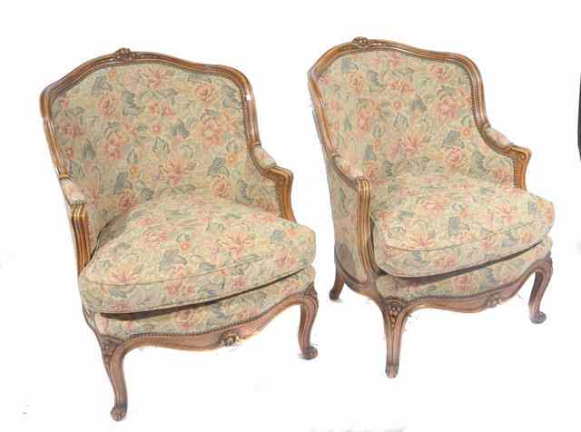 Appraisal: A PAIR OF CONTINENTAL WALNUT FRAMED FLORALLY UPHOLSTERED ARMCHAIRS standing