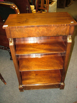 Appraisal: An Empire style mahogany open bookcase with frieze drawer flanked