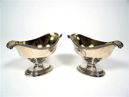 Appraisal: A pair of George III double lipped pedestal sauce boats