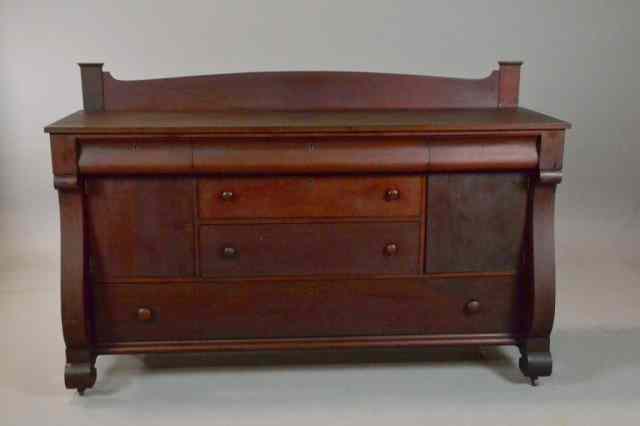 Appraisal: AMERICAN EMPIRE MAHOGANY SIDEBOARDWith three drawers over two doors centered