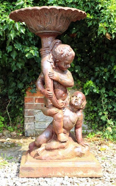 Appraisal: A CAST IRON FOUNTAIN in the form of two Putti