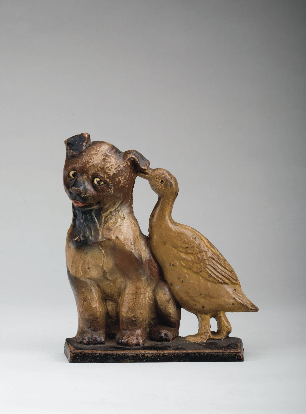 Appraisal: CAST-IRON DOORSTOP IN THE FORM OF A PUPPY AND DUCK