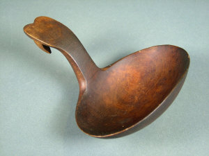 Appraisal: A Welsh carved wooden spoon the handle with hooked terminal