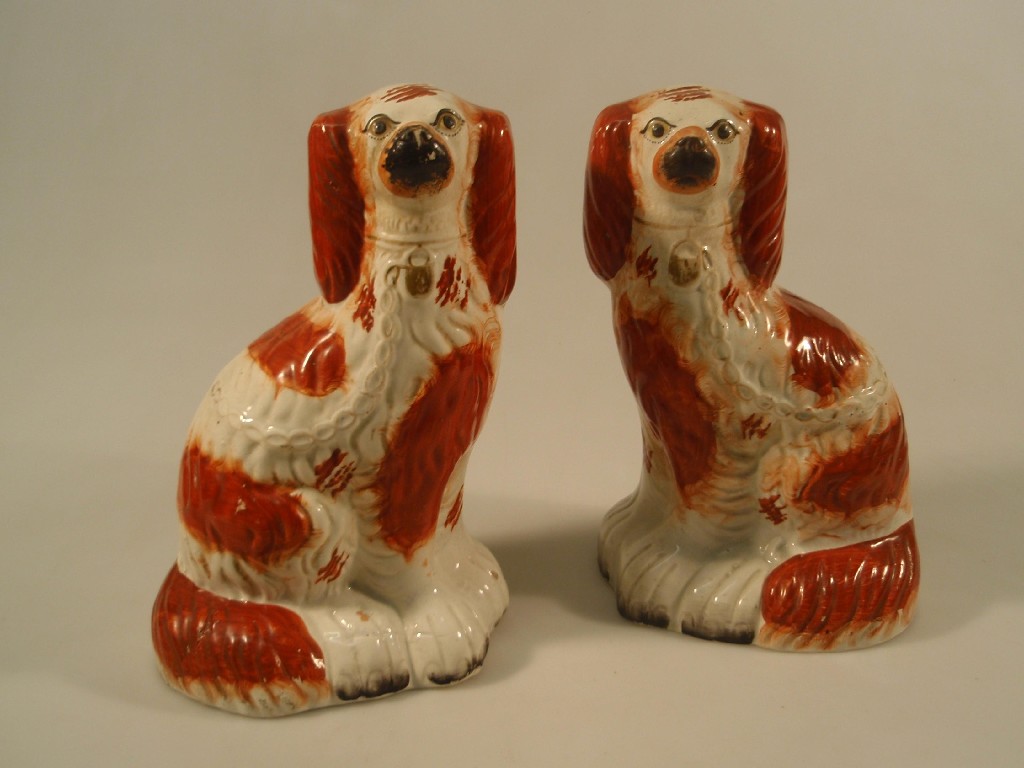 Appraisal: A pair of Staffordshire pottery spaniels with red sponged coats