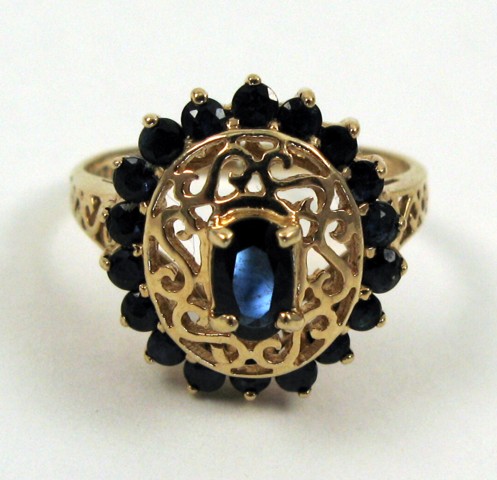 Appraisal: SAPPHIRE AND FOURTEEN KARAT GOLD RING set with an oval-cut