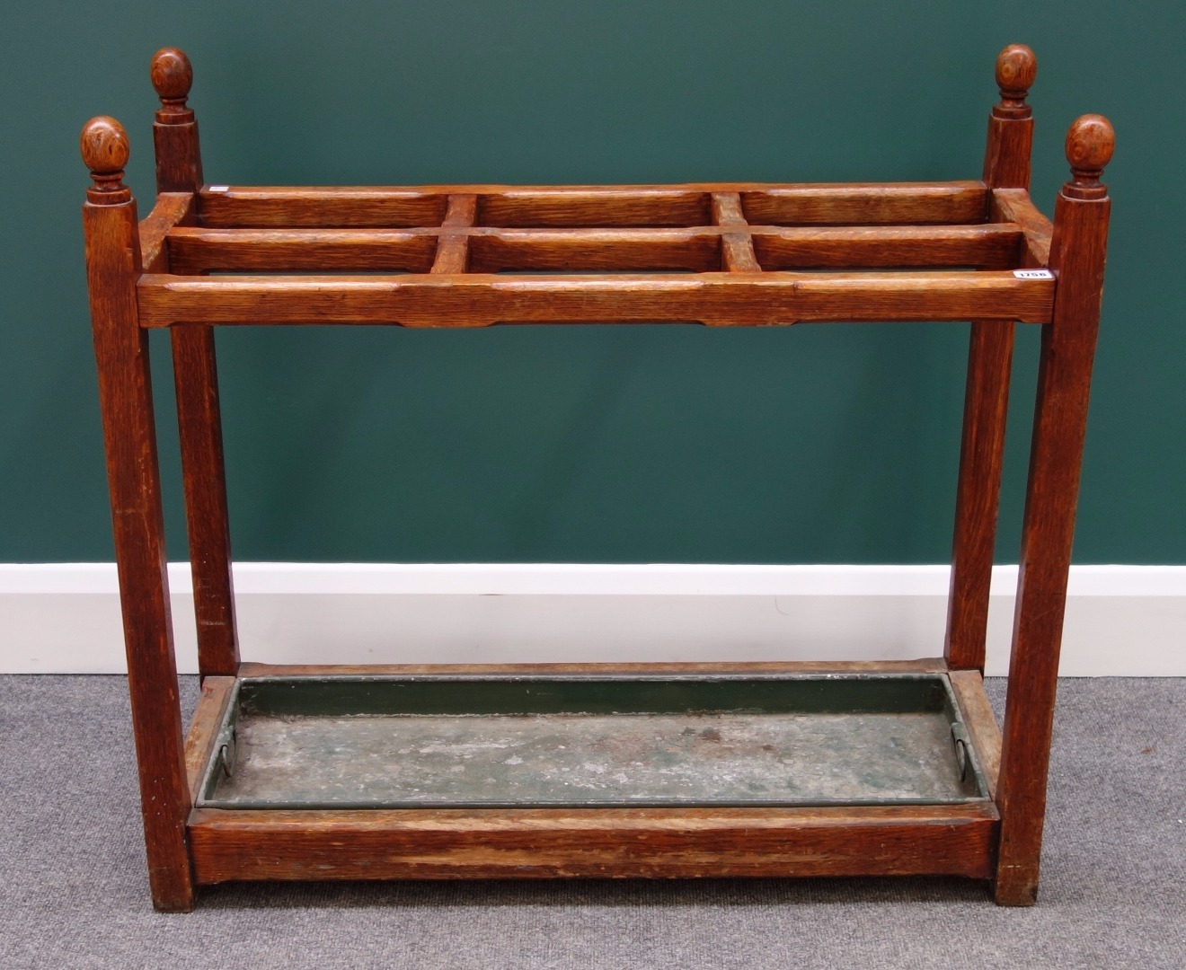 Appraisal: A Victorian oak four division stick stand with ball finials