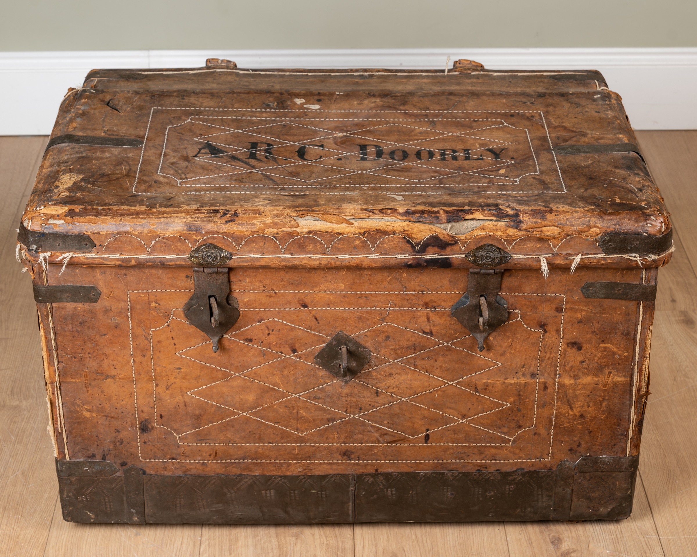 Appraisal: A th century leather and iron bound trunk with wrought