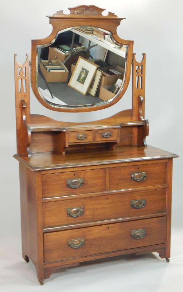 Appraisal: A Victorian walnut dressing table the top with a shield