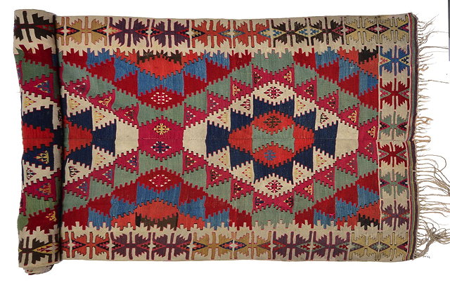 Appraisal: A TURKISH KONYA KELIM with a repeating multi-coloured stylistic design