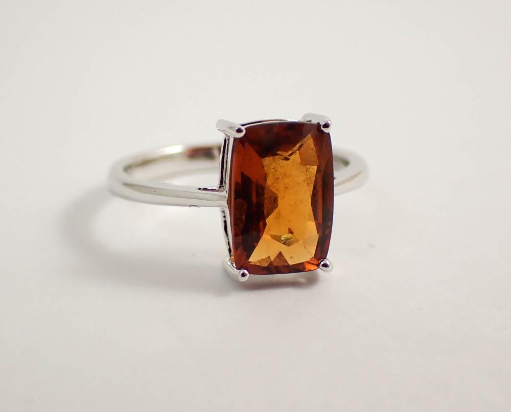 Appraisal: HESSONITE GARNET AND FOURTEEN KARAT WHITE GOLD RING set with