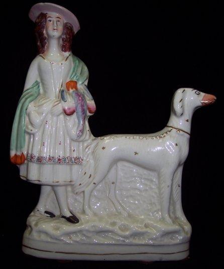 Appraisal: A Staffordshire figure girl with greyhound on an oval base