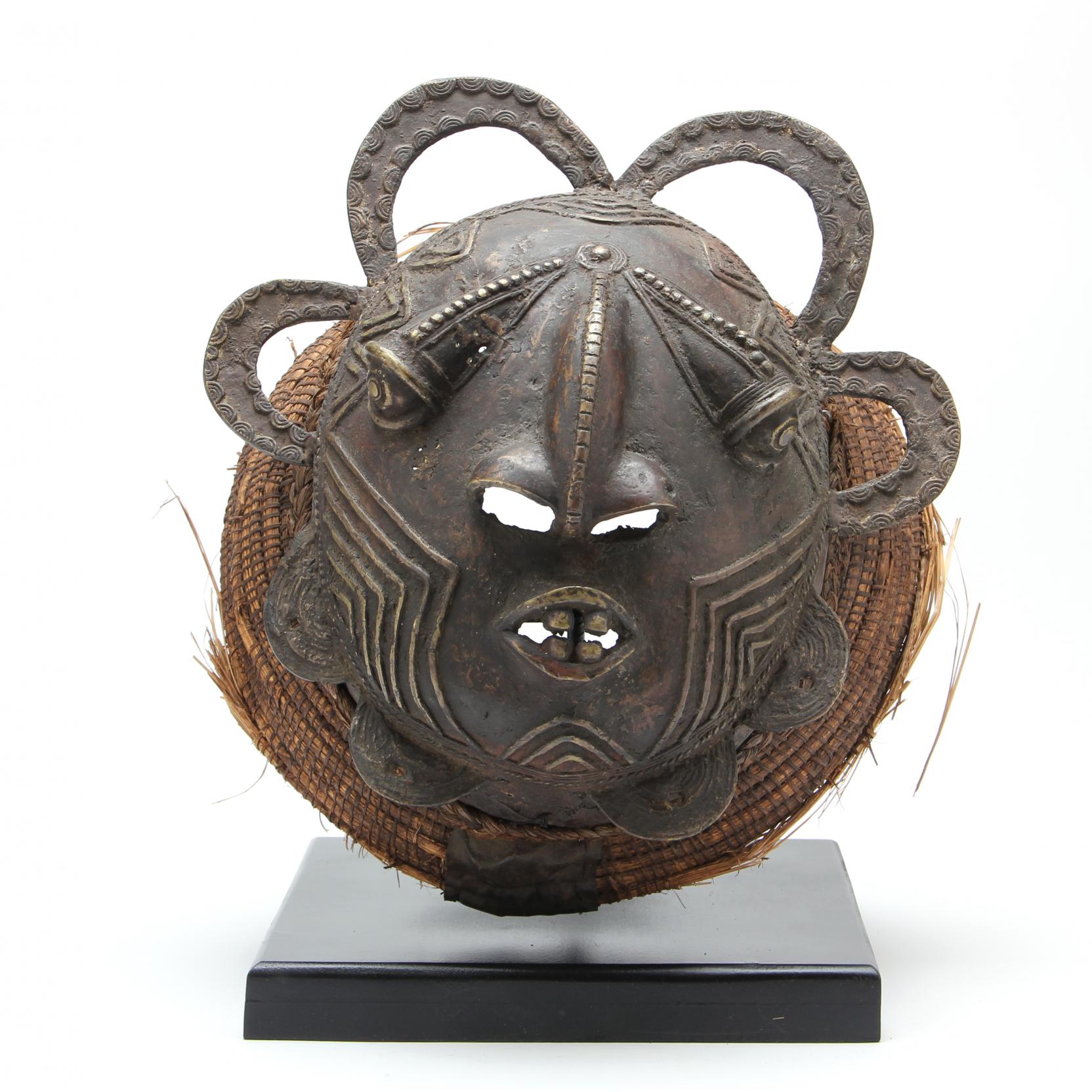 Appraisal: West African Bronze Mask Cameroon the effigy resting in a