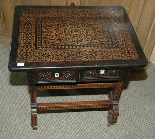 Appraisal: A SPANISH WALNUT EBONY AND MARQUETRY LOW TABLE The rounded