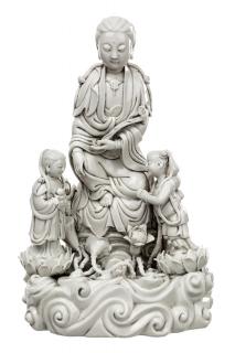 Appraisal: A BLANC-DE-CHINE FIGURE OF GUANYIN ON A ROCK WITH TWO