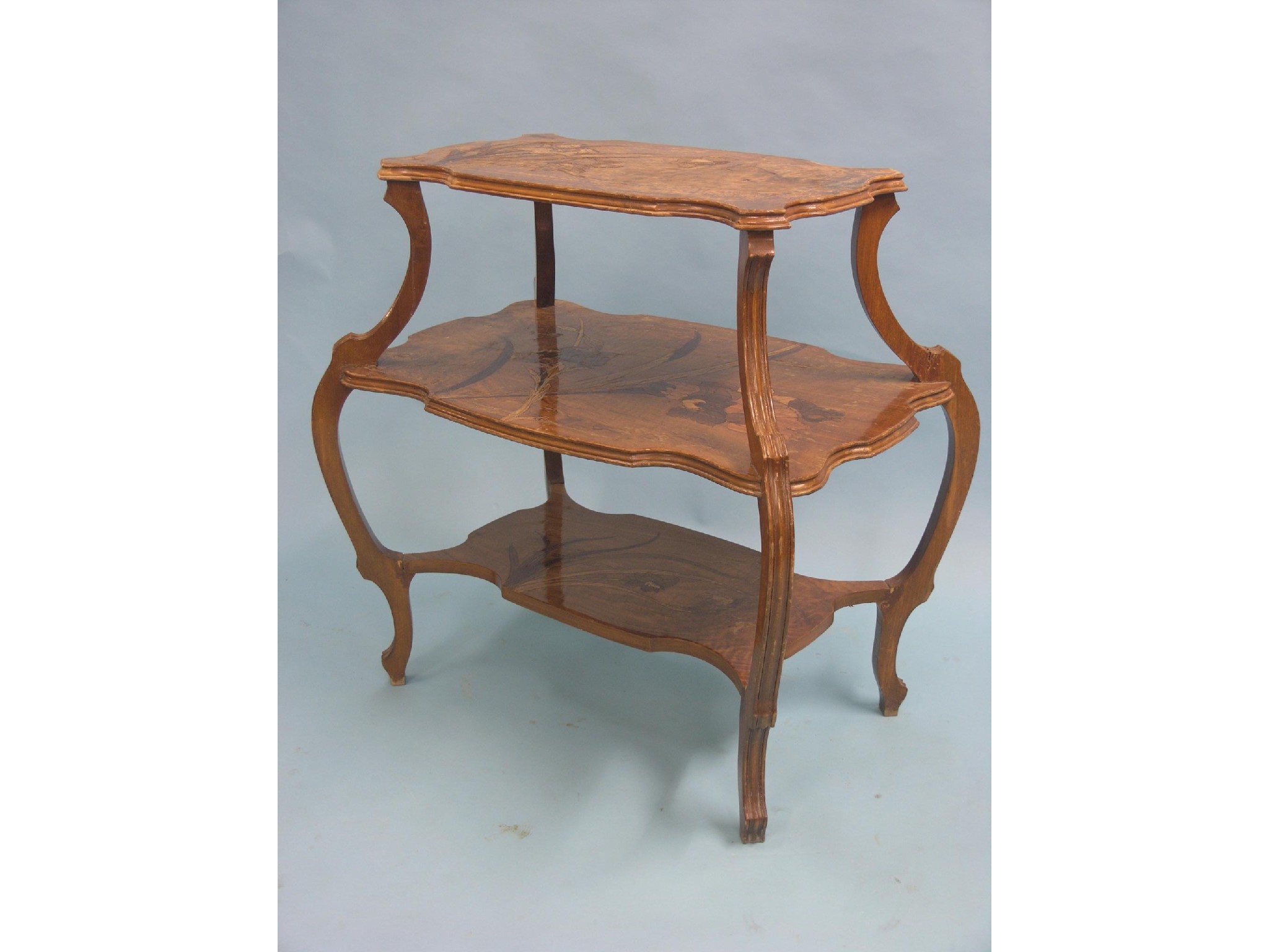 Appraisal: A Galle-style marquetry etagere three-tiered inlaid with plant-life on moulded