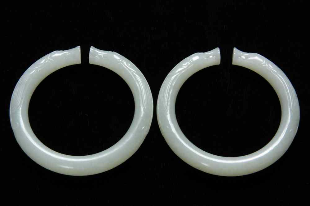 Appraisal: PAIR OF CHINESE JADE BRACELETS - Pair of Caved White