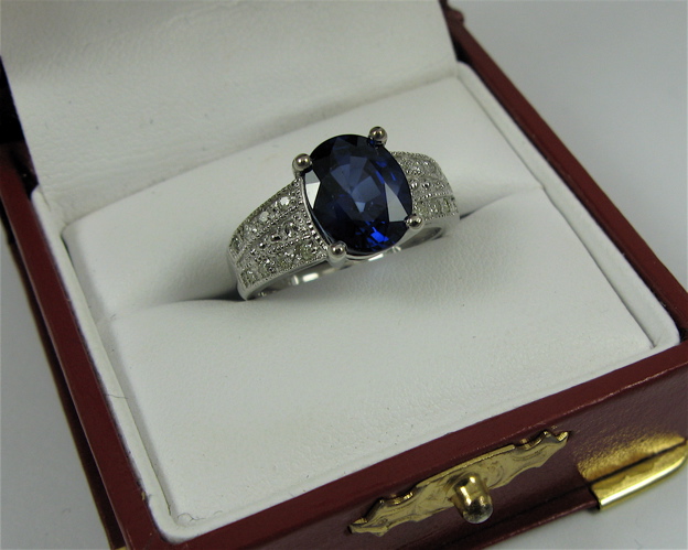 Appraisal: SAPPHIRE DIAMOND AND K WHITE GOLD RING centering an oval-cut