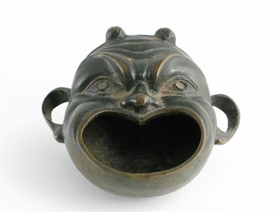 Appraisal: A Japanese bronze incense burner cast as a grotesque Noh