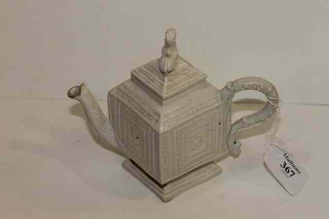 Appraisal: A STAFFORDSHIRE SALT GLAZED WHITE STONEWARE TEAPOT and cover circa