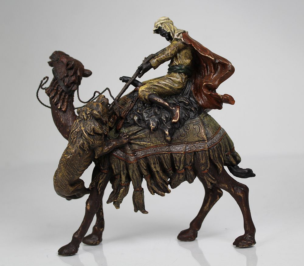 Appraisal: Bronze Orientalist Figure on Camel Shooting Lion Cold-Painted Bronze Orientalist