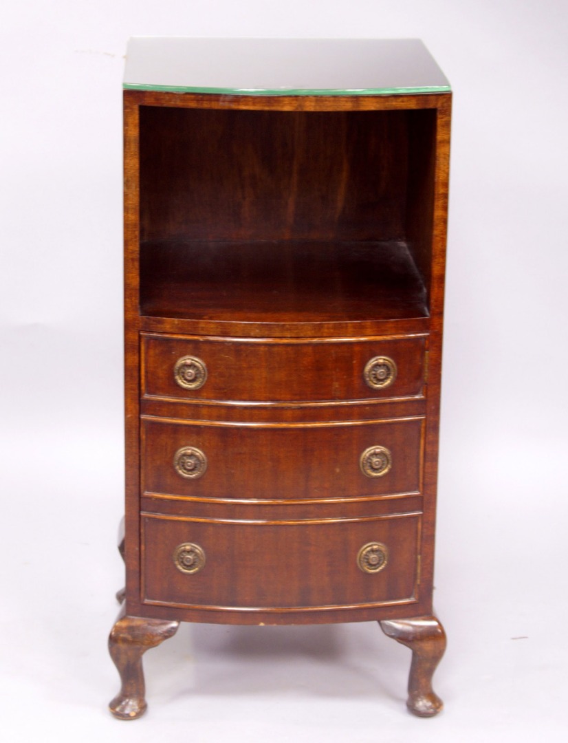 Appraisal: A reproduction mahogany bow fronted bedside cabinet with a recess