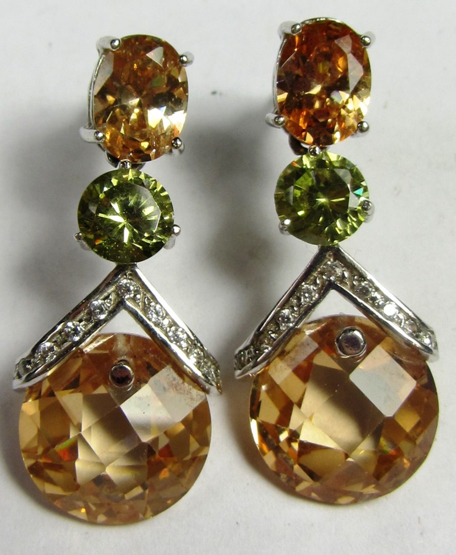 Appraisal: A pair of pale green and brown gem set and