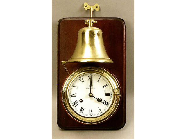 Appraisal: Nice quality West German brass ship-style clock mounted on mahogany