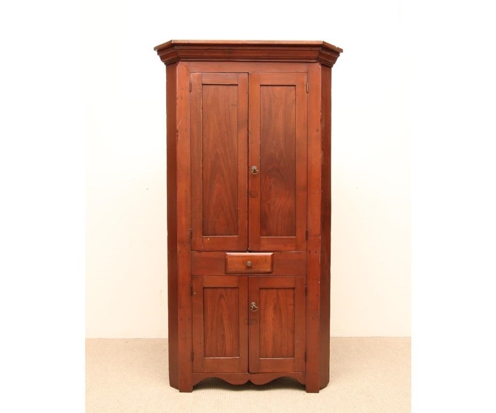 Appraisal: One-piece walnut blind door corner cupboard circa with molded cornice