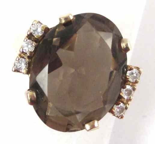 Appraisal: SMOKY QUARTZ AND TEN KARAT GOLD RING three round-cut CZ