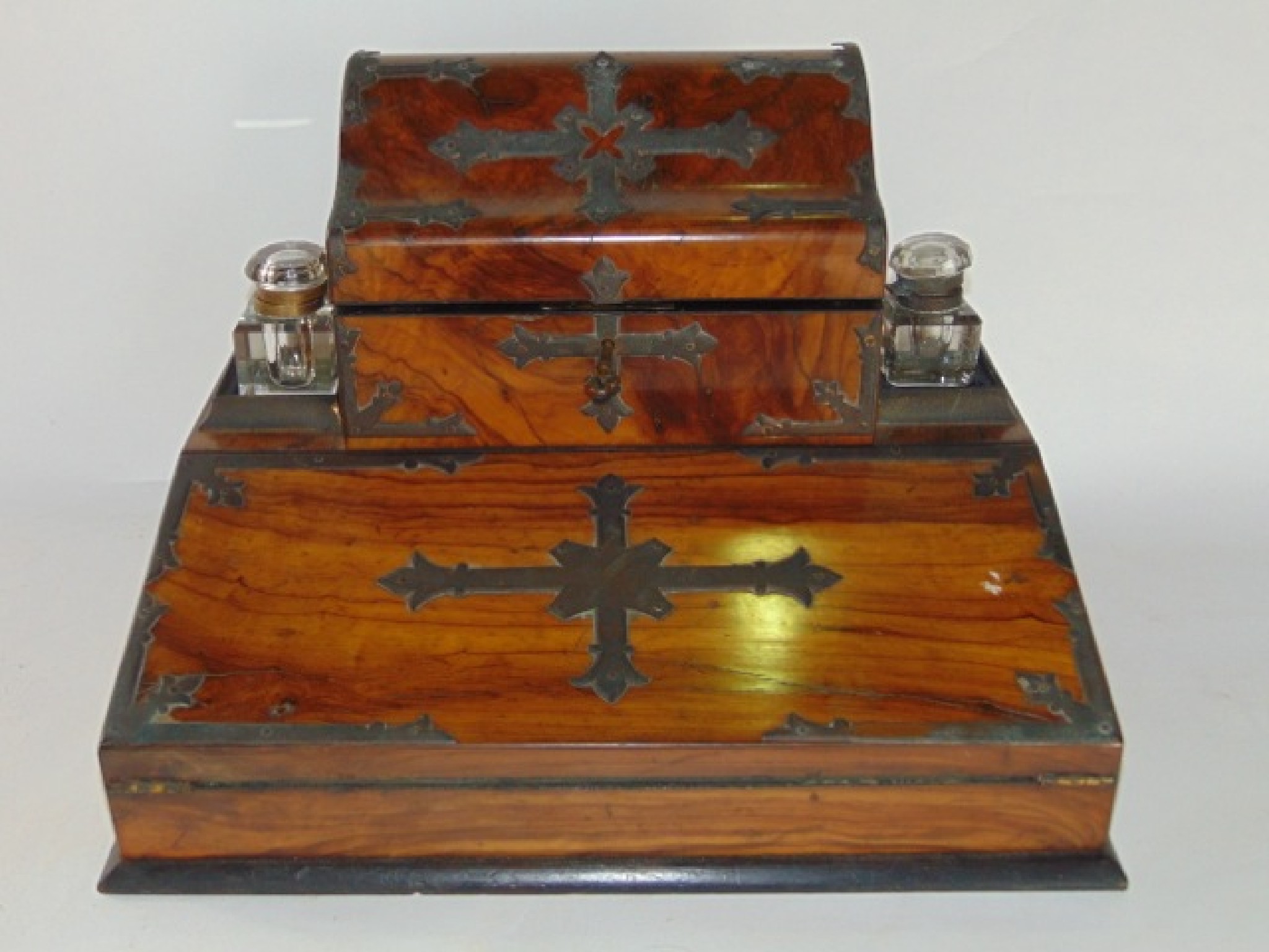 Appraisal: A Victorian olive wood veneered desk standish with applied metallic