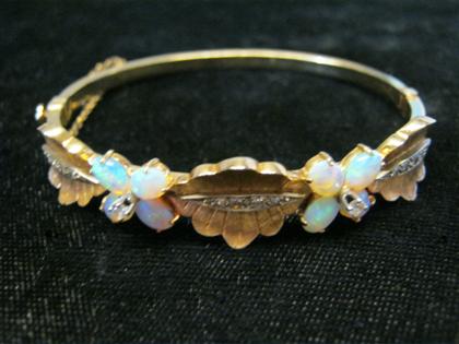 Appraisal: karat yellow gold opal and diamond bangle braceletFloral design with