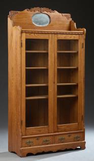 Appraisal: American Victorian Carved Oak Display Cabinet c the arched back