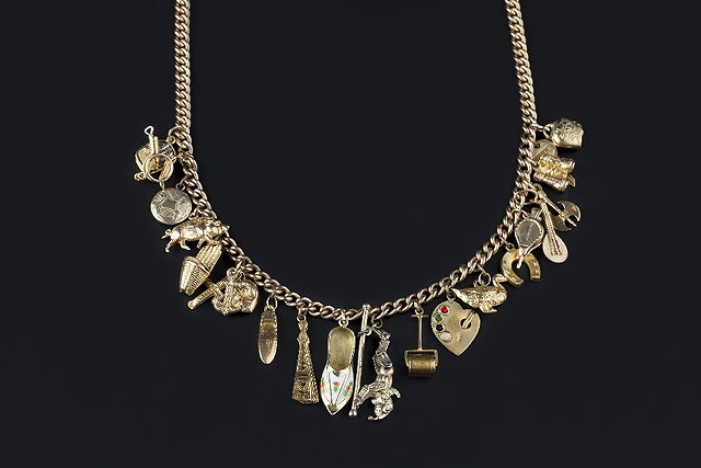 Appraisal: A CHARM NECKLACE the ct gold curb-link chain suspending a