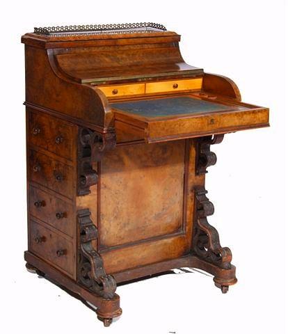 Appraisal: A VICTORIAN WALNUT 'PIANO TOP' DAVENPORT with brass gallery rising