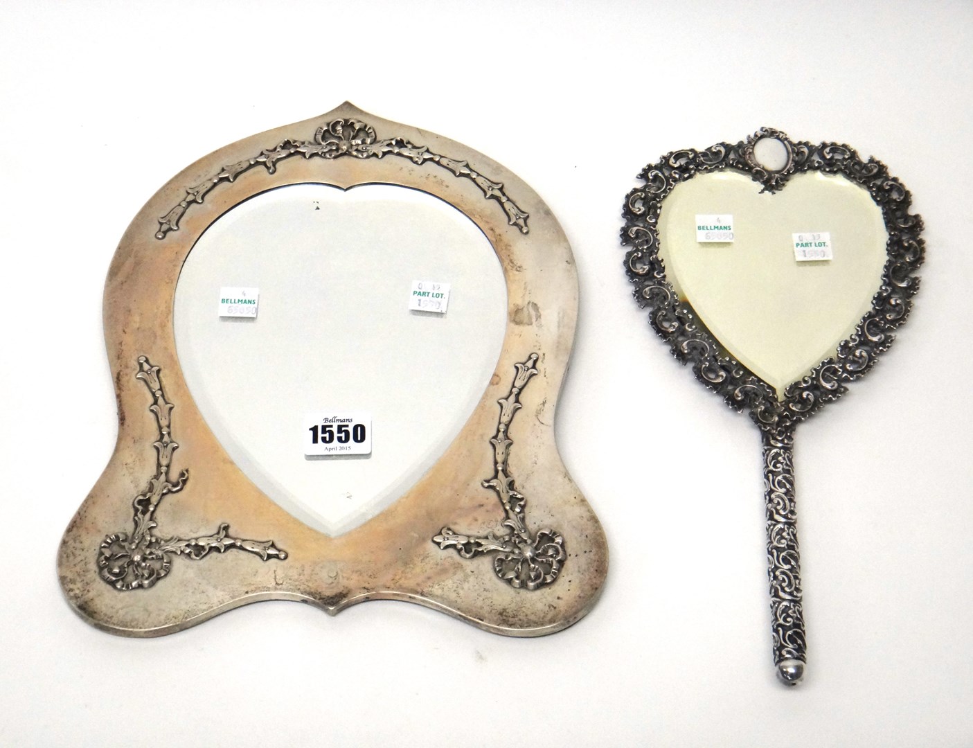 Appraisal: A silver mounted heart shaped mirror applied with ribbon tied