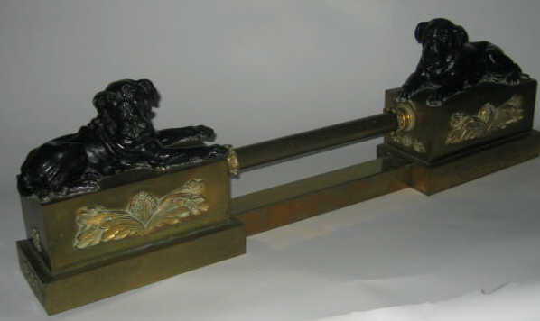 Appraisal: CONTINENTAL GILT BRONZE FIGURAL FIREPLACE FENDER Showing two dogs lying